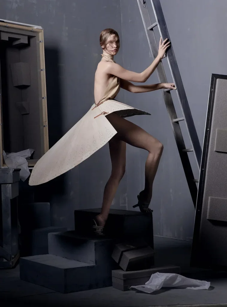 On model Karlie Kloss leather halter top and wood fan skirt
